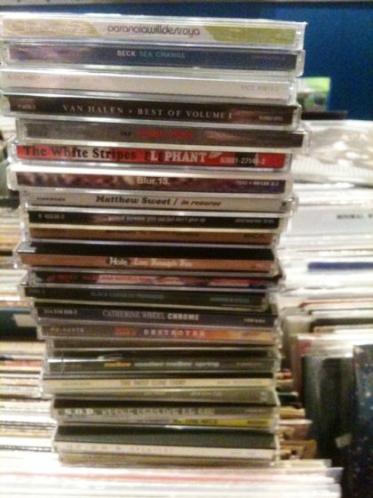 a stack of used CDs